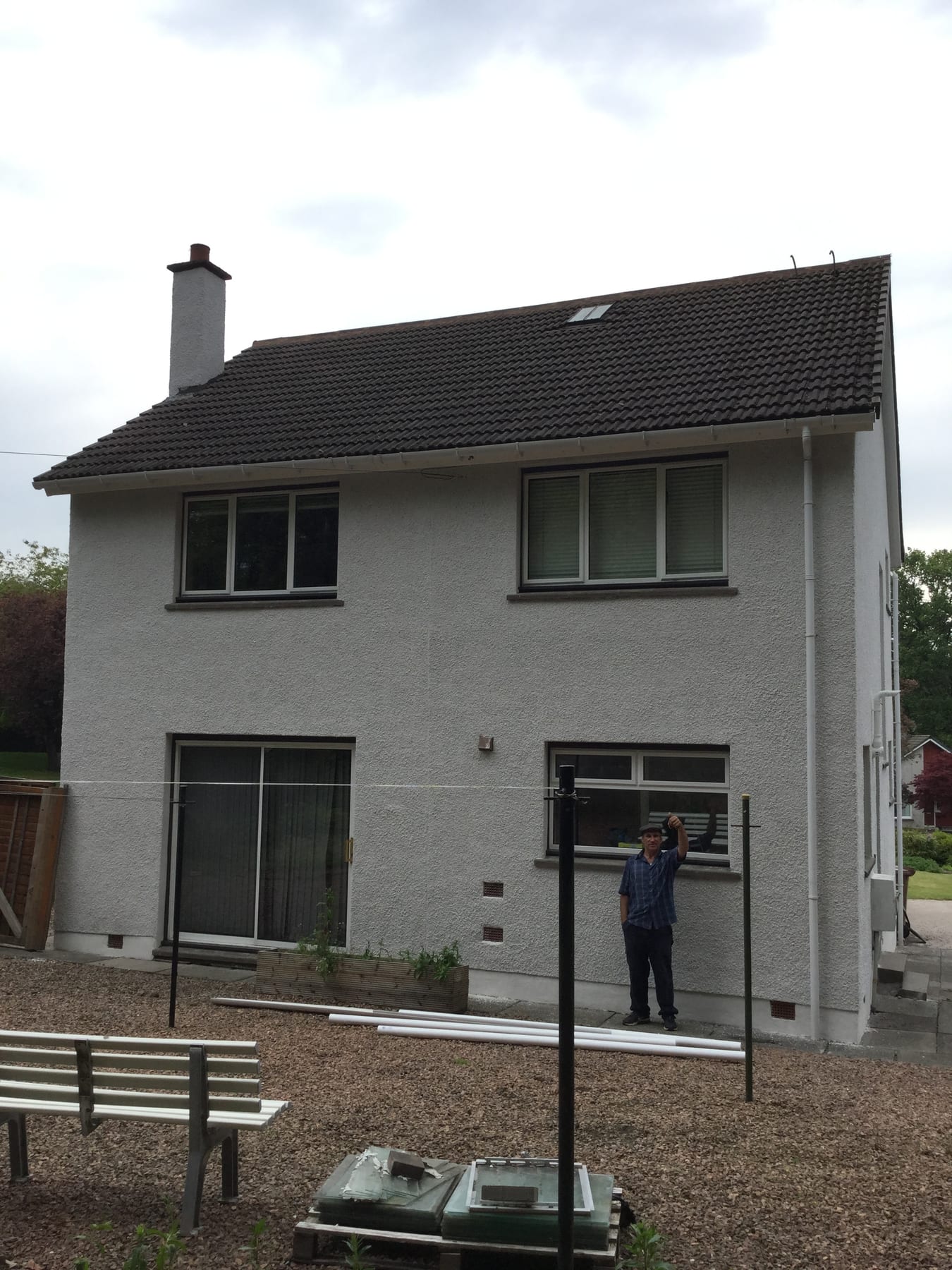 A detached house with a fresh white roughcast finish