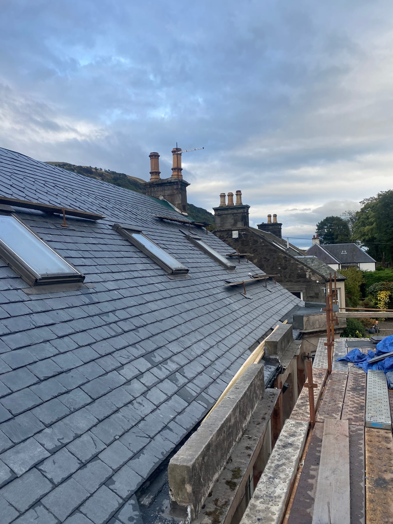 Row of Velux windows installed in a newly slated roof